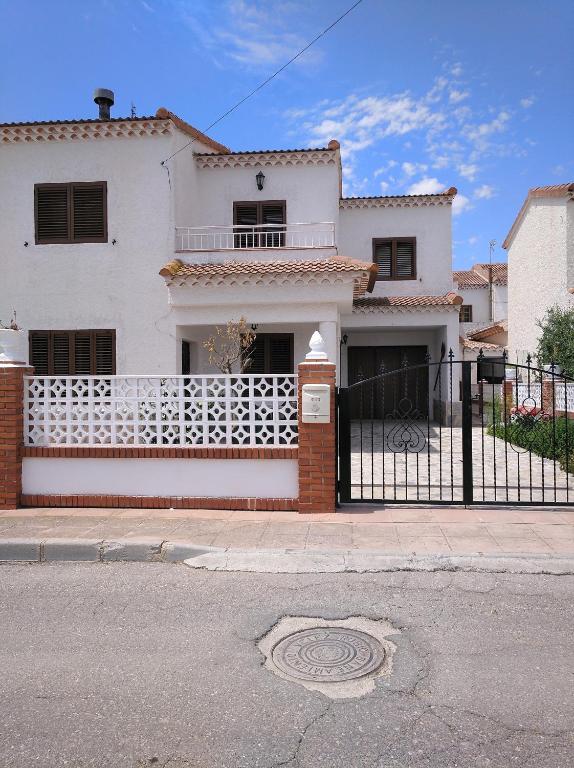 a white house with a fence in front of it at CASA EL LAUREL in Vélez-Rubio
