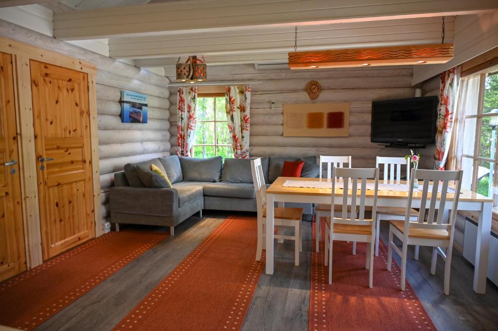 - un salon avec une table et un canapé dans l'établissement Rukajärven Lomamajat Apartment 4, à Ruka
