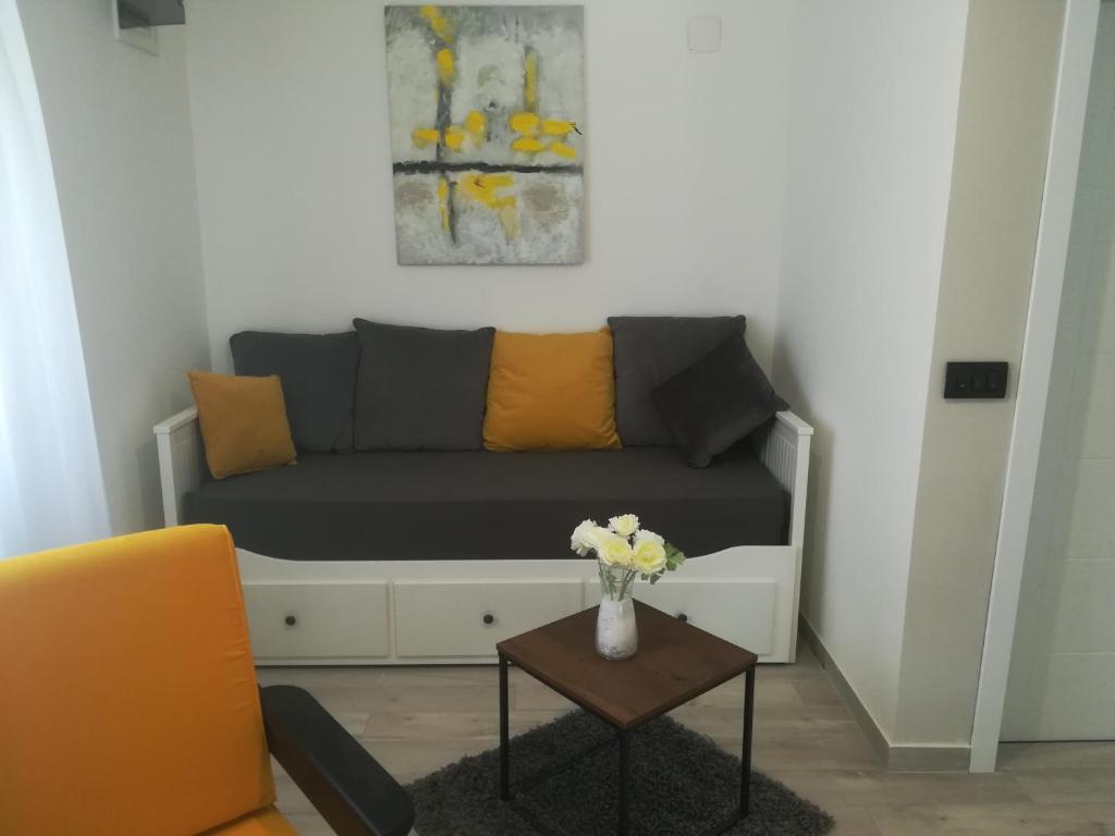 a living room with a couch and a table at Apartmani HERMES Jadrija in Šibenik