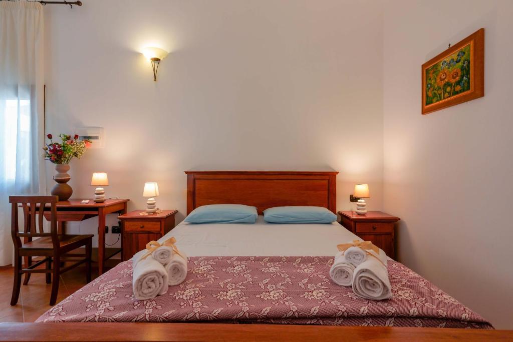 a bedroom with a bed with towels on it at Bed and Breakfast Cairoli Exclusive Room in San Pietro Vernotico