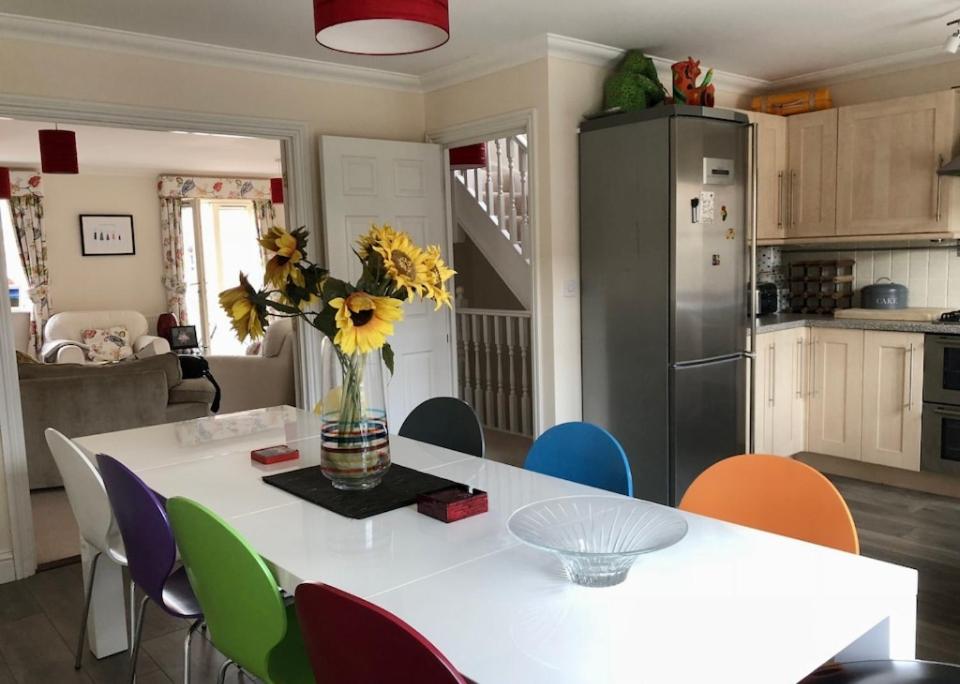 a kitchen with a table with a vase of flowers on it at Norwich City Large Modern Home in Norwich