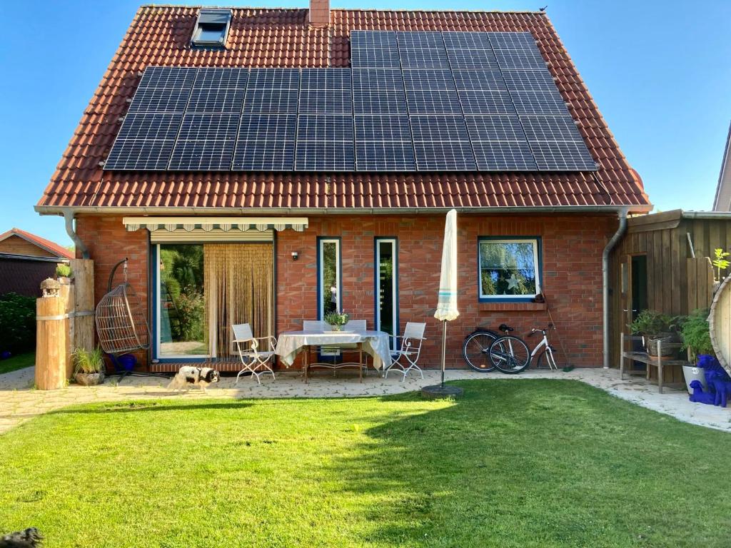 une maison avec beaucoup de panneaux solaires sur son toit dans l'établissement Ferienhaus Elisenhuus, à Tönning