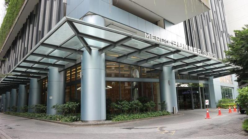 a large building with blue columns in front of it at Summer Suites Apartment @KLCC by Sarah's Lodge in Kuala Lumpur