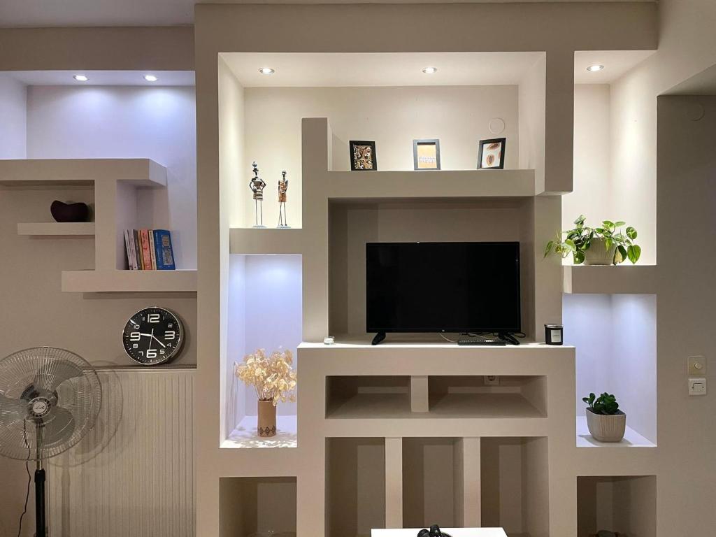 a living room with a tv on a wall at VillaGer in Kalamata
