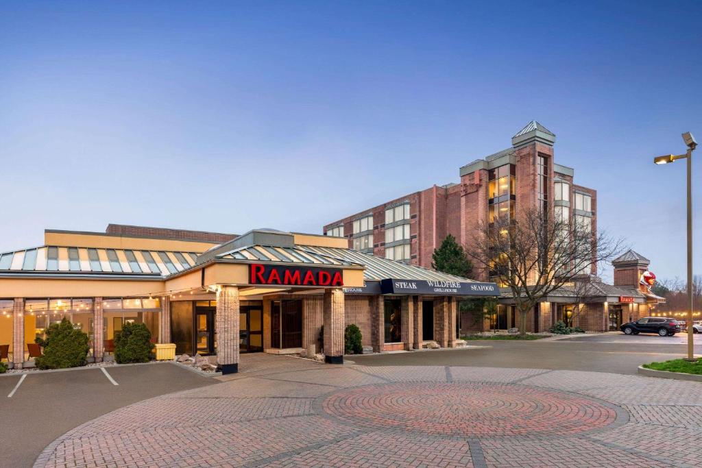 a building with a karamota sign in a parking lot at Ramada Plaza by Wyndham Niagara Falls in Niagara Falls