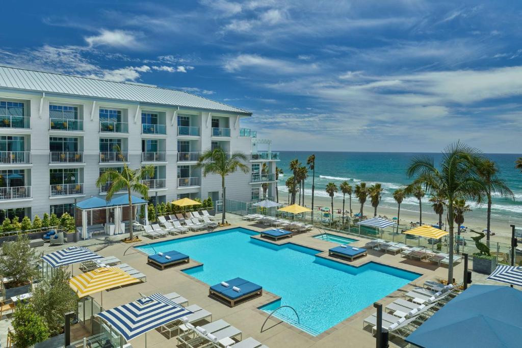 an image of a hotel with a pool and the ocean at The Seabird Resort - part of Destination by Hyatt in Oceanside