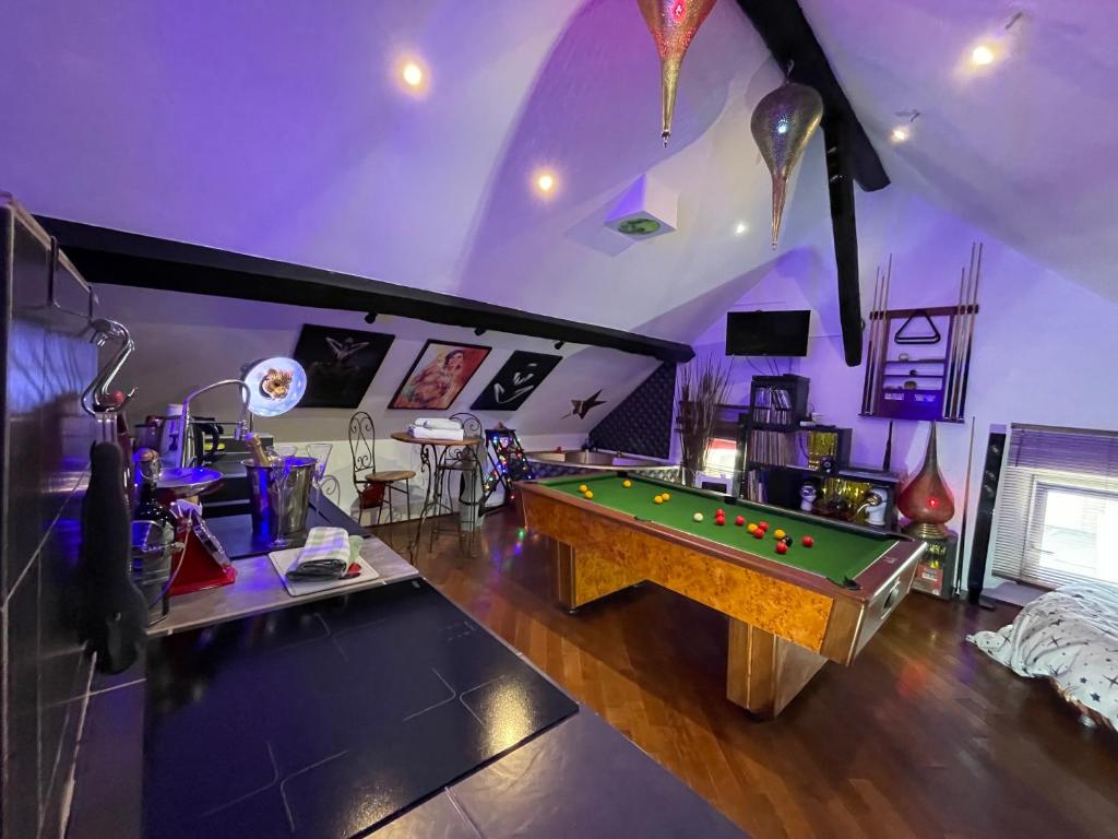 a living room with a pool table in it at Chambre & Lounge Privé Jacuzzi in Marolles-en-Hurepoix