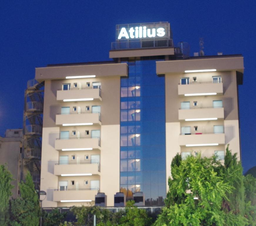 a building with a sign on top of it at Hotel Atilius & Suites in Riccione