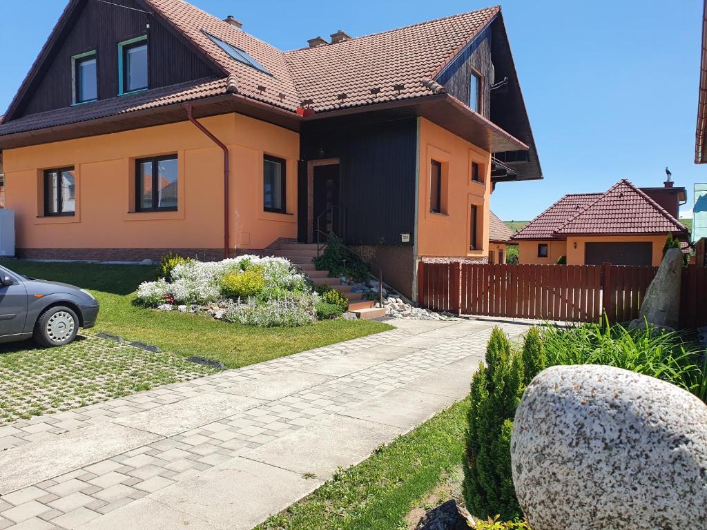 a house with a driveway in front of it at Šarmír Apartmány in Bobrovec