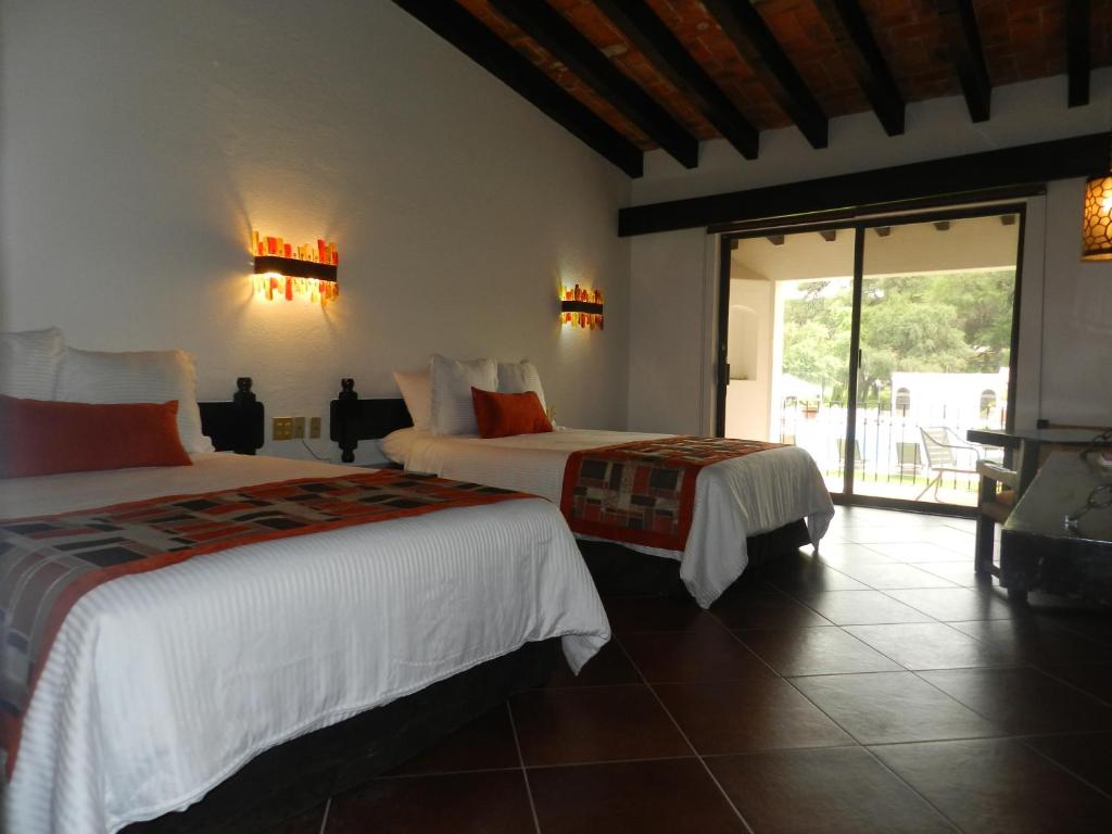 Postel nebo postele na pokoji v ubytování Hotel Hacienda Taboada (Aguas Termales)