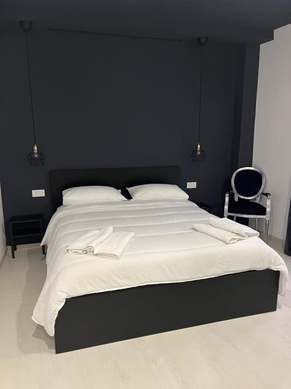 a bedroom with a large bed with a black headboard at Residenza Marcelli in Isernia