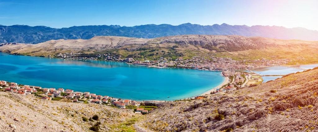 an aerial view of a lake in the mountains at Apartment Murvica in Pag