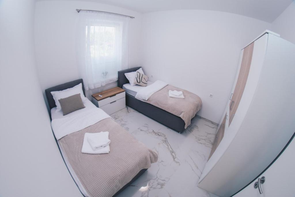 Postel nebo postele na pokoji v ubytování L Apartment