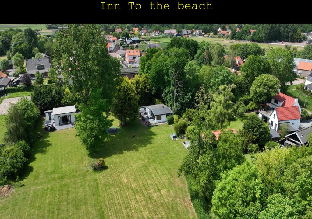 an overhead view of a yard with houses and trees at Inn To the beach in Ouddorp