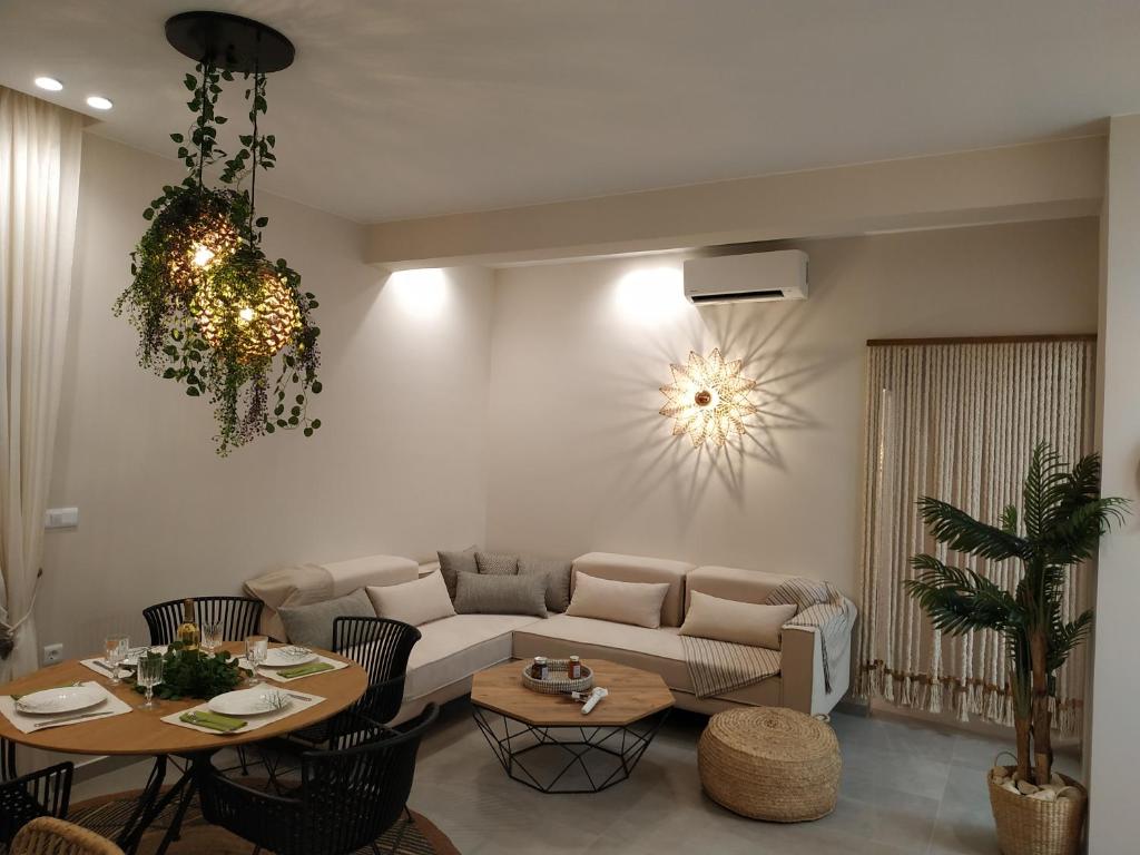 een woonkamer met een bank en tafels bij Christina Kos Boutique Apartments in Kos-stad