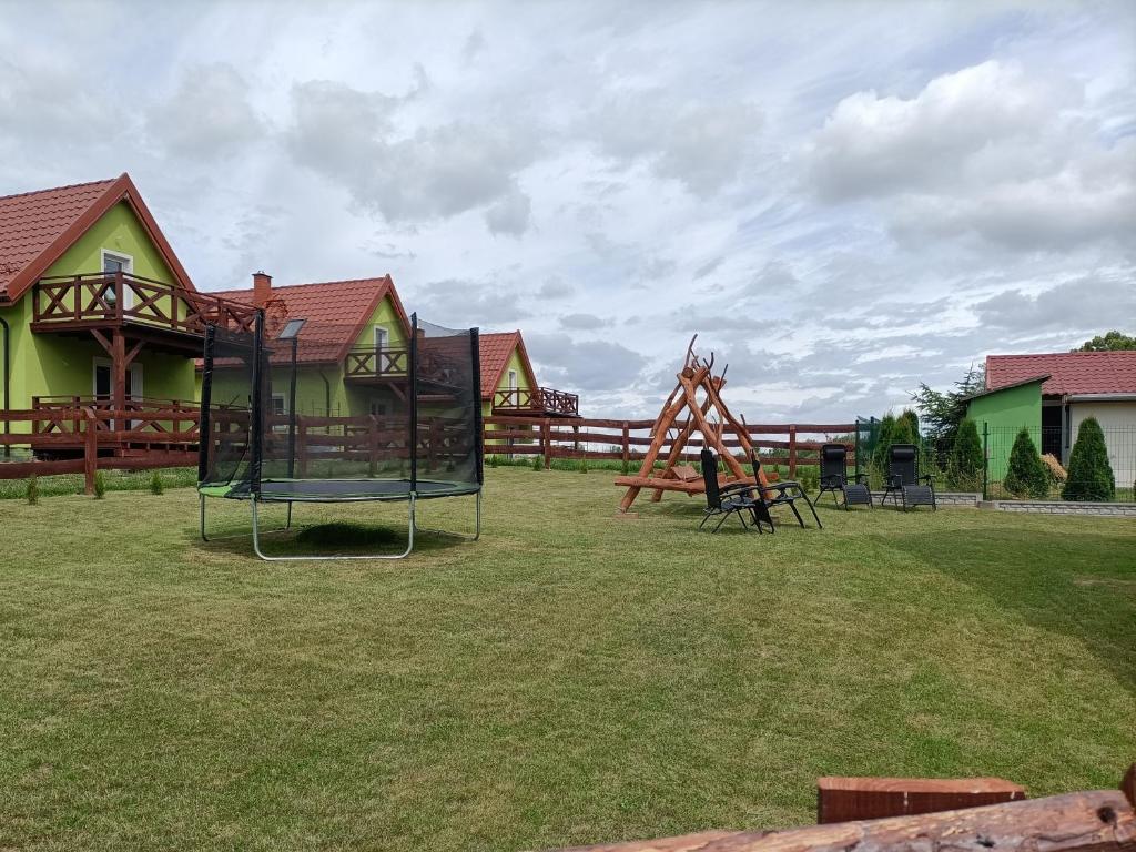 a park with a playground with a play equipment at Zielona Ostoja in Ryn