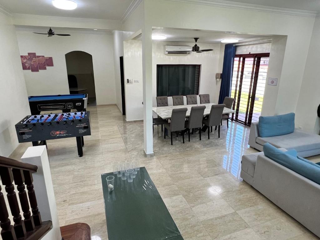 a living room with a ping pong table and a dining room at PH Homestay Bungalow House at PJ Fully Equipped in Petaling Jaya