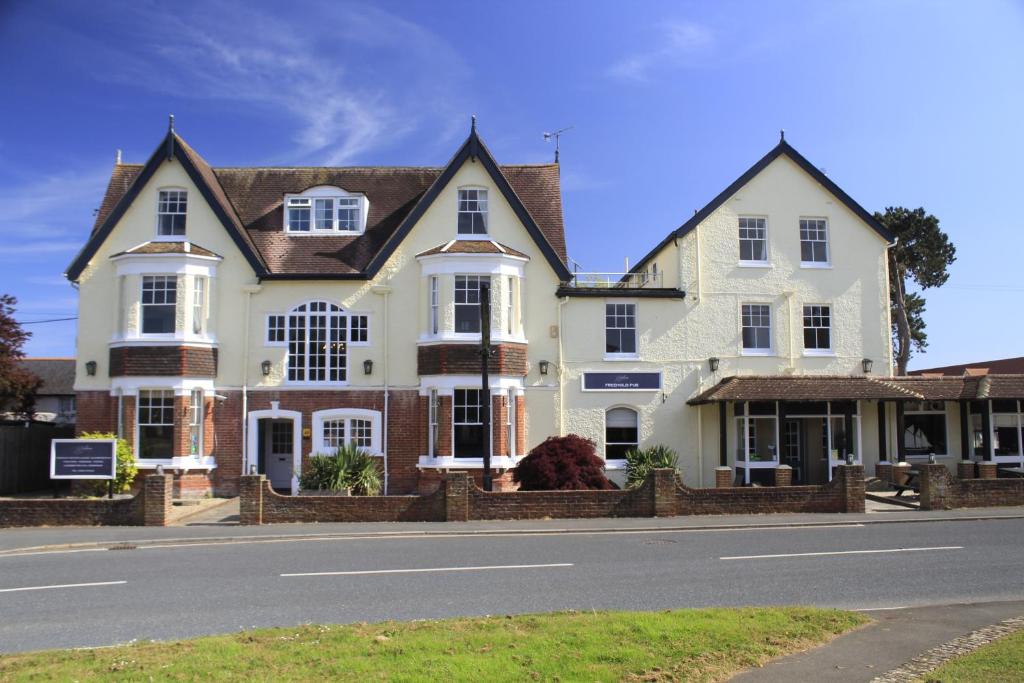 a large house on the side of the road at The Birdham At Bembridge in Bembridge