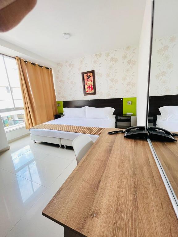 Postel nebo postele na pokoji v ubytování Hotel Suite Center Pereira