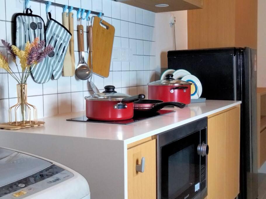 a kitchen with pots and pans on a stove at Signature 1 Bedroom EnSuite 3Pax, Sunway BRT Lagoon Pyramid in Petaling Jaya
