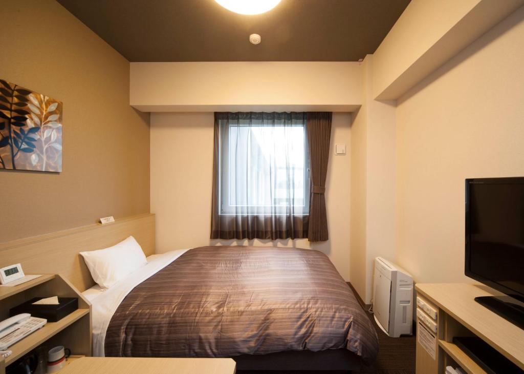 Postel nebo postele na pokoji v ubytování Hotel Route Inn Ono