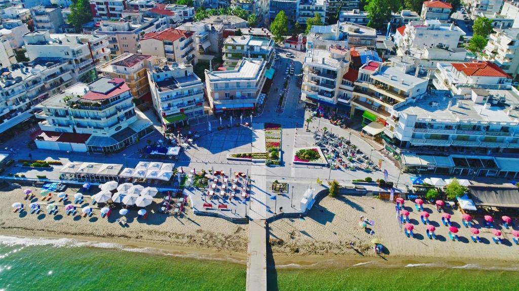an aerial view of a beach with chairs and umbrellas at Rena's Traditional Aegean House by the Sea in Perea