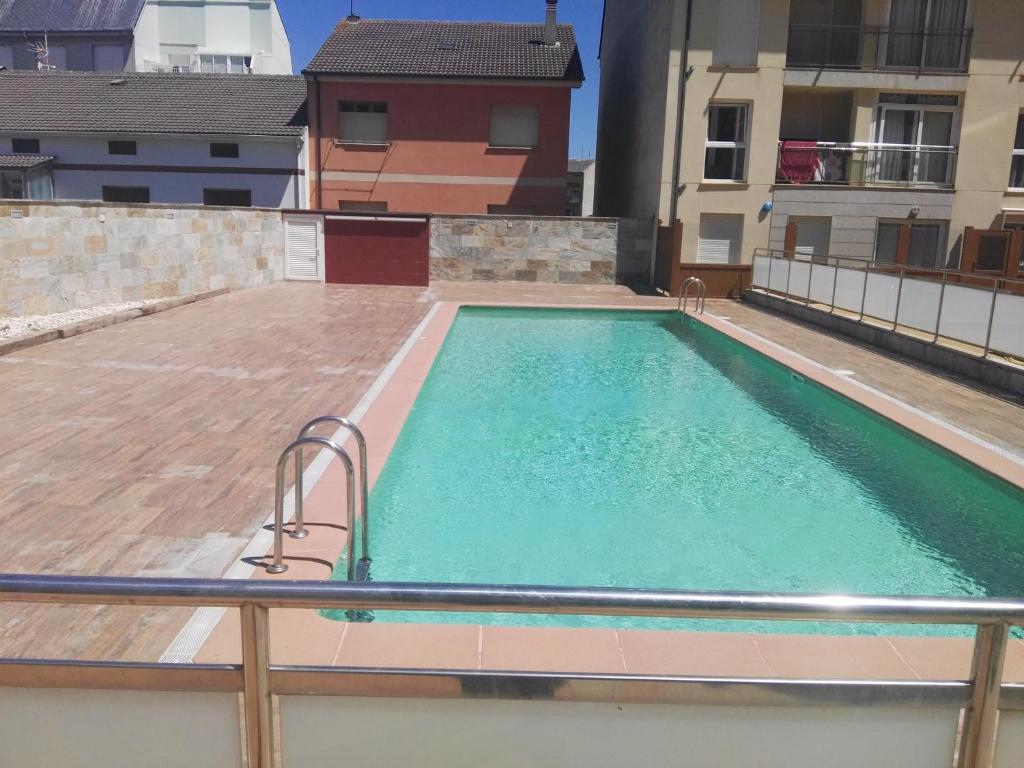 a swimming pool on the roof of a building at EnSAN CIPRIAN JARDINES DEL MAR in San Ciprián