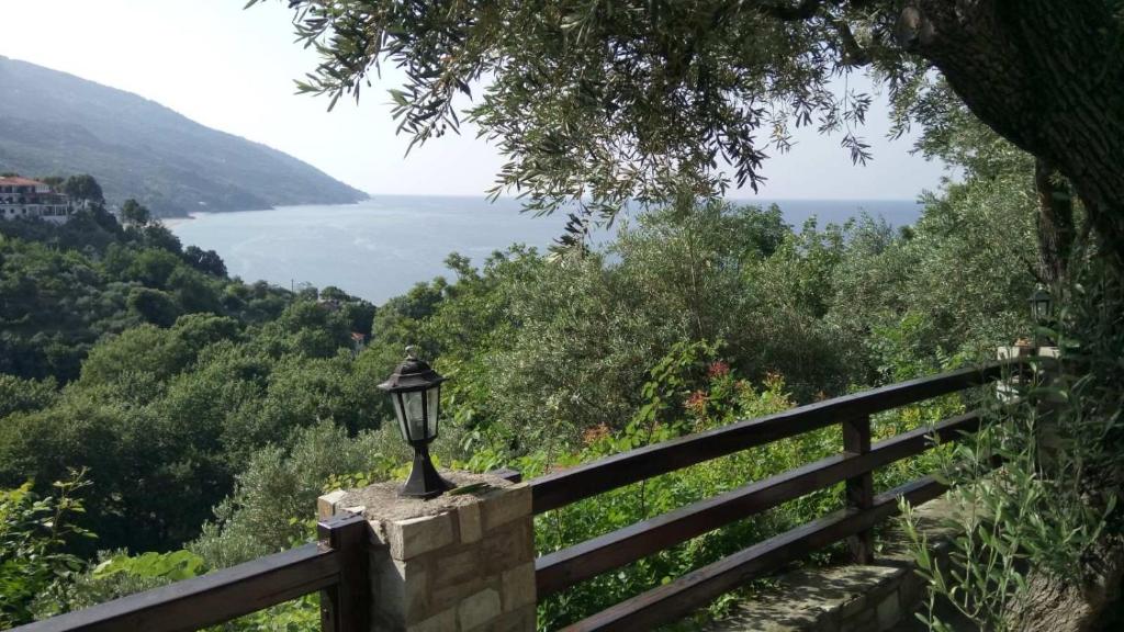 a lamp on a fence with a view of the water at Alex Seaview House in Chorefto