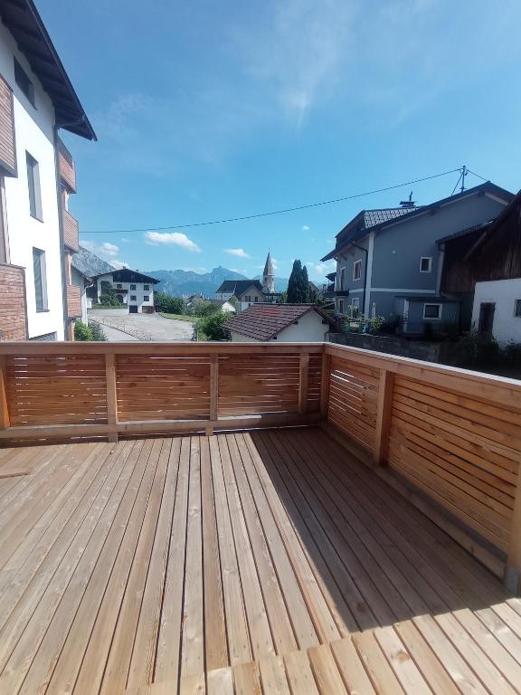 a wooden deck with a view of a house at Rittertal-Altholzseeblick in Altmünster