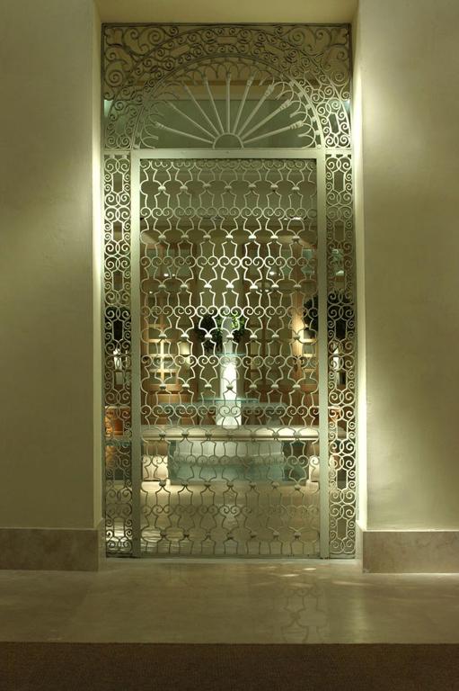 a room with a glass door with a patterned wall at Villa Oniria in Granada