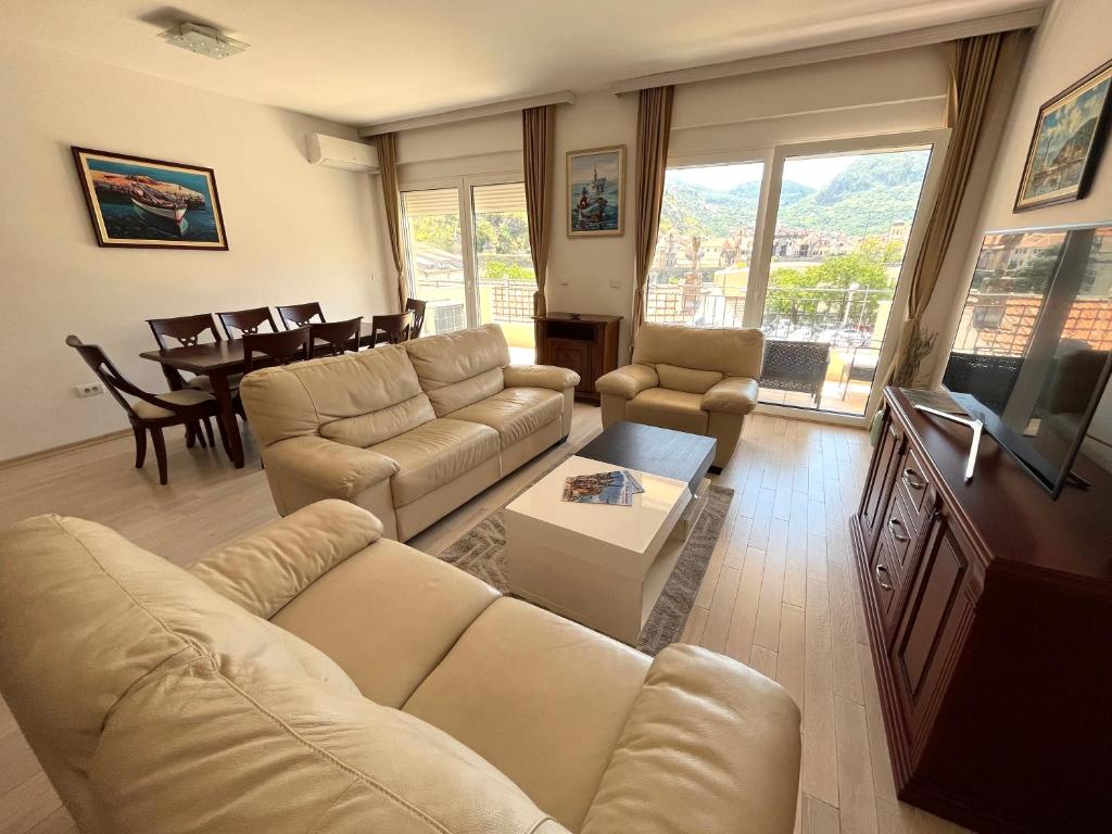a living room with a couch and a tv at Villa K LUX in Kotor
