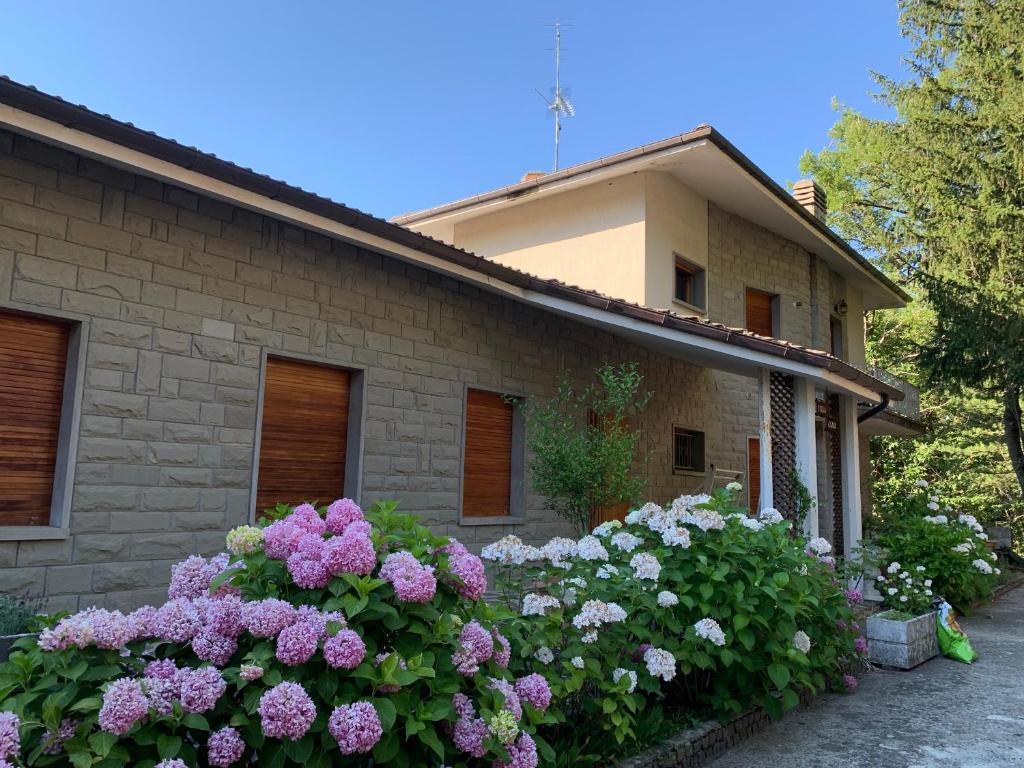 a house with flowers in front of it at Peaceful Country Living at Apartments at Villa Clara in Vimignano