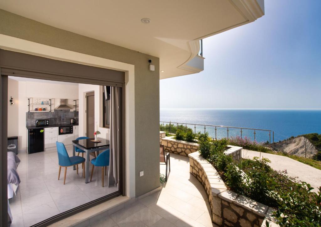 a balcony with a view of the ocean at MELIKIRON LUXURY APARTMENTS in Ayios Nikitas
