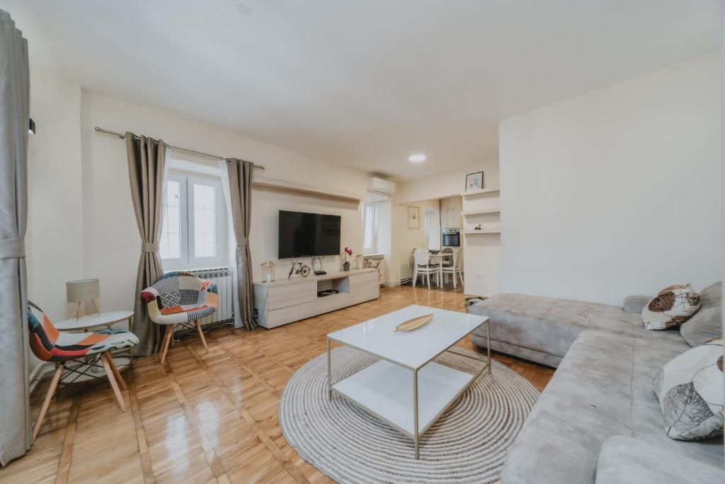 a living room with a couch and a table at Regina apartments in Budva