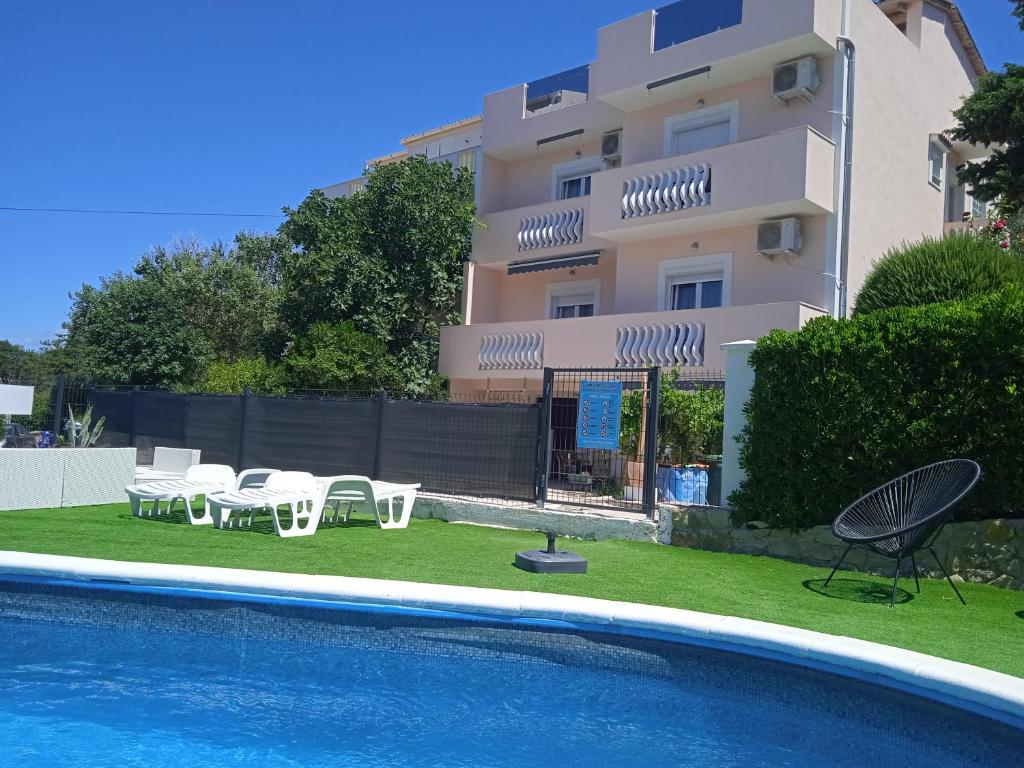 a apartment with a swimming pool and a building at Villa Marin in Pag