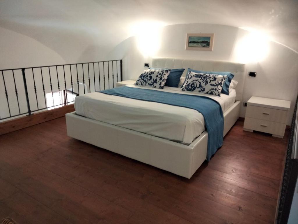 um quarto com uma cama com almofadas azuis e brancas em L'Ancorotto Azzurro em Gaeta