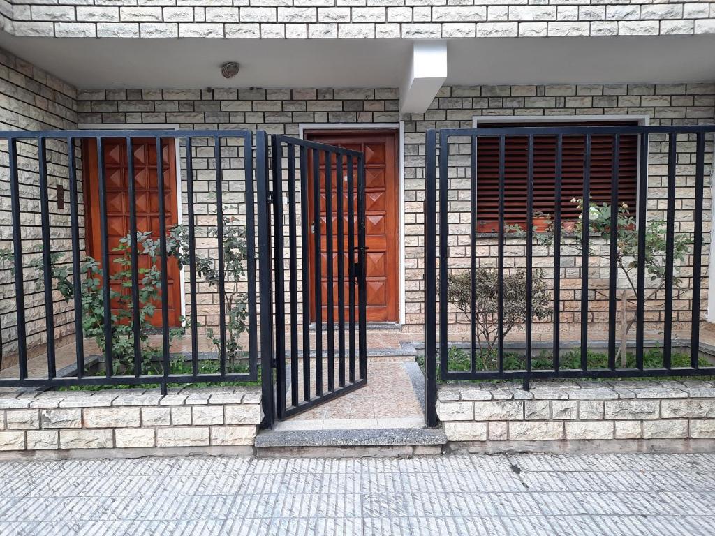 a gate on the side of a building with two doors at Apart Centro- VICTORIA555 in Libertador General San Martín