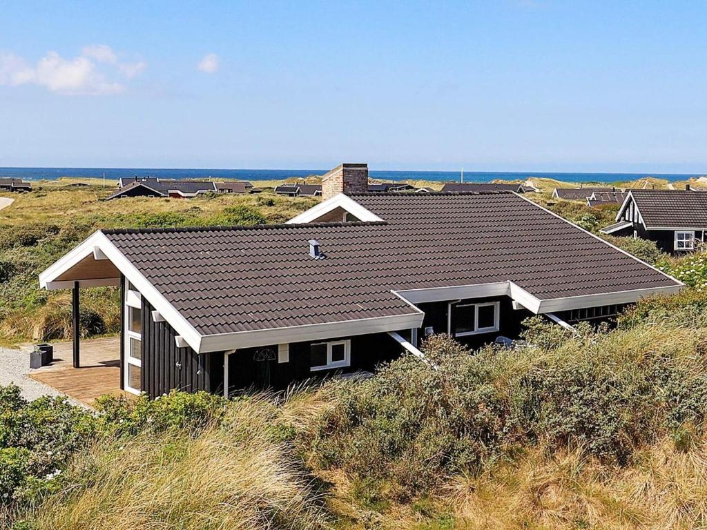 a house sitting on top of a hill at Luxury Retreat with Sea View - By Traum Ferienwohnungen in Hjørring