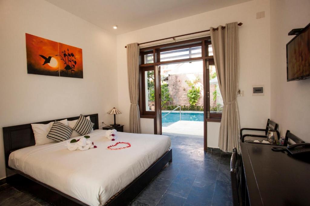 Giường trong phòng chung tại Hoi An TNT Villa