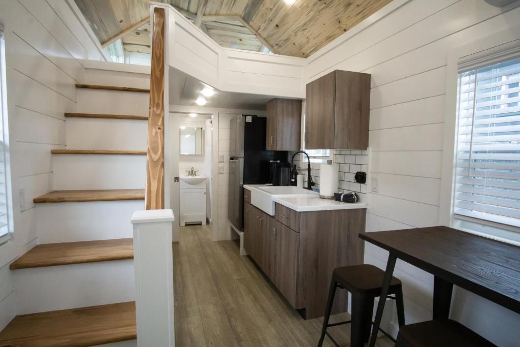 a tiny house with a kitchen and a table at Teton Peaks Resort in Tetonia