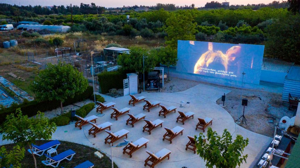 an overhead view of a stage with chairs and a large screen at Fitosinn Hotel in Paphos
