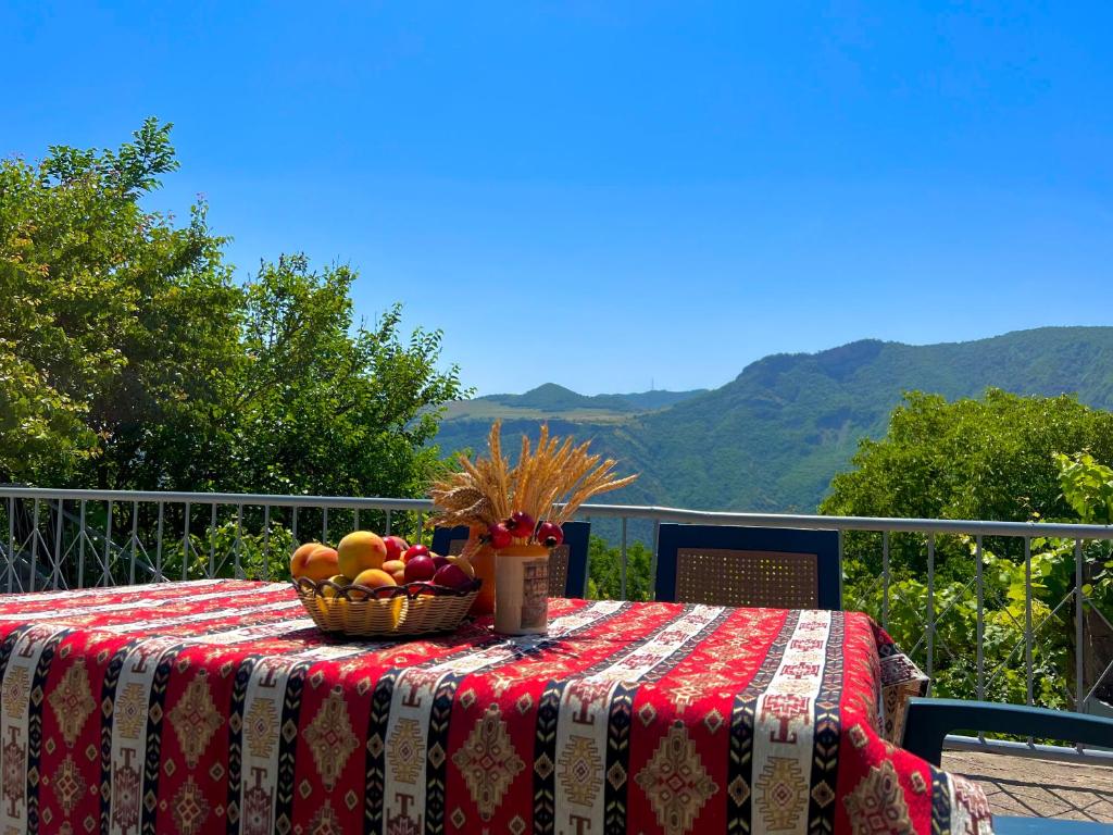 a table with a basket of fruit on top of it at Igor Bed and Breakfast in Halidzor