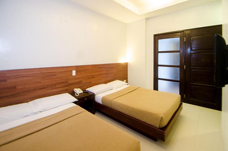 Letto o letti in una camera di Taj Guesthouse Boracay