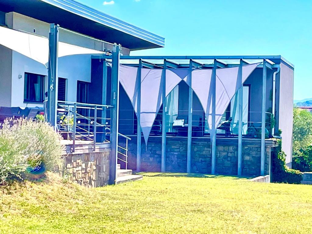 a house with glass doors on the side of it at MEGA in Prvačina