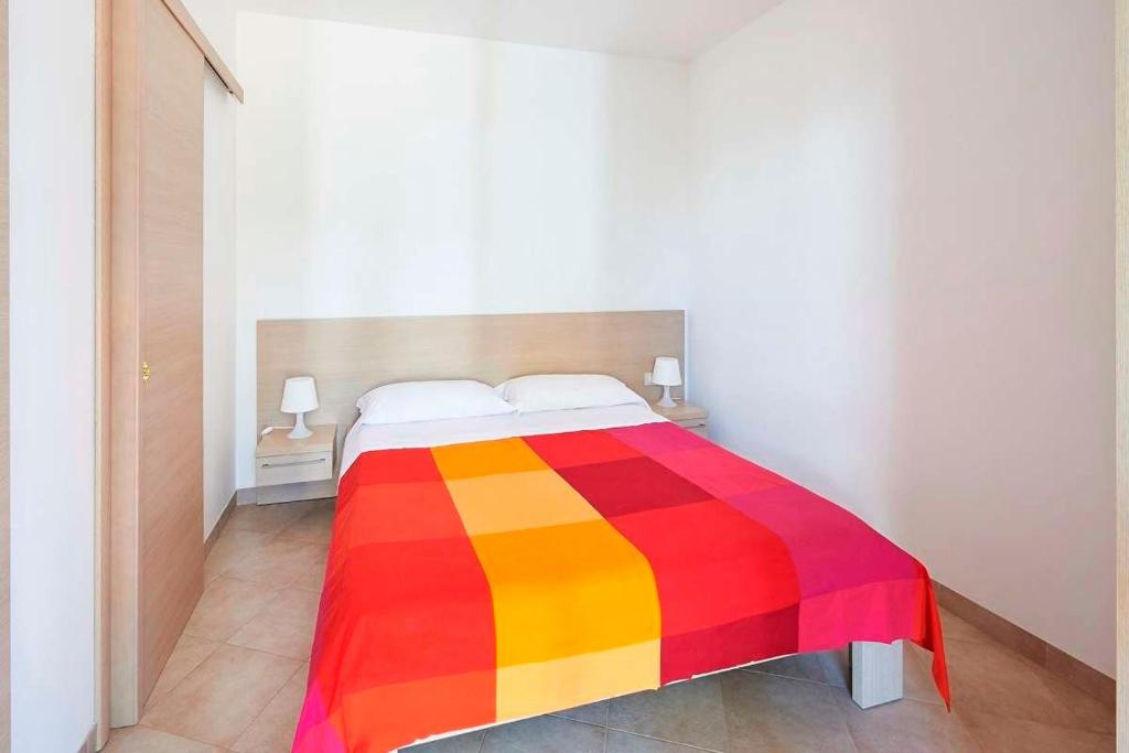 Postel nebo postele na pokoji v ubytování Camping Cala dei Ginepri