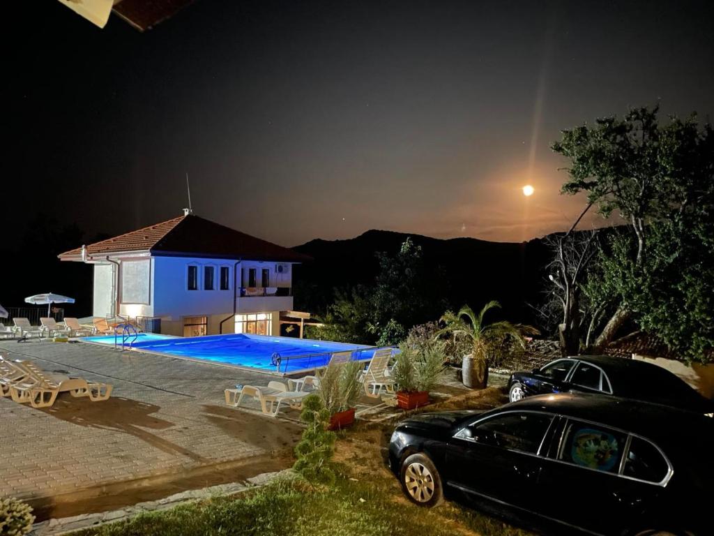 a car parked in front of a house at night at Бадевски рай-къща Надежда in Badewzi