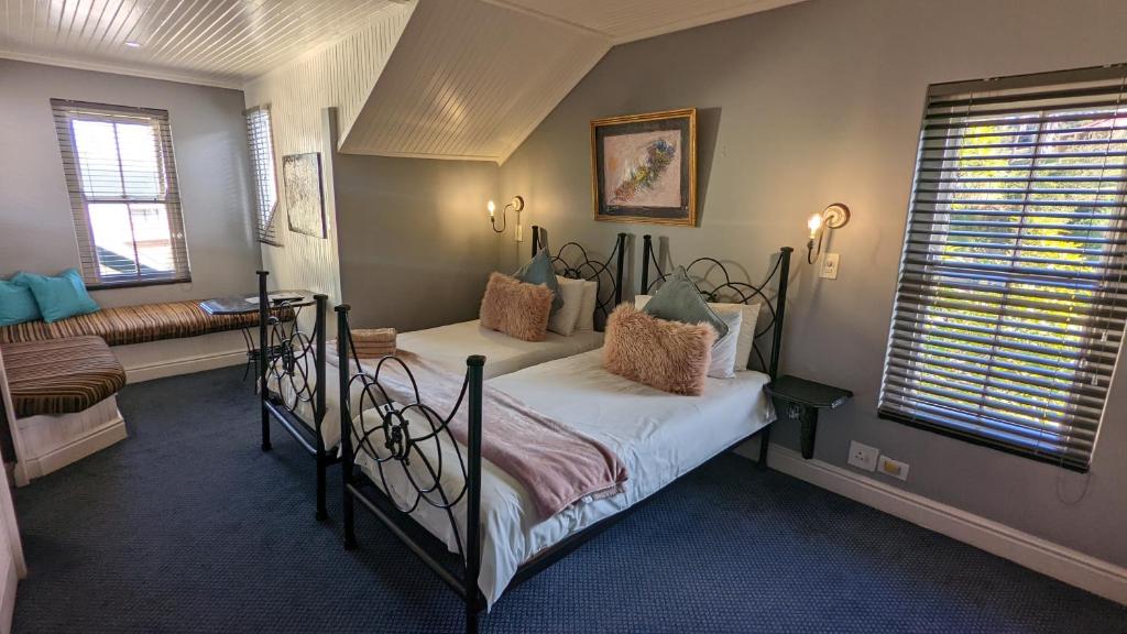 1 dormitorio con cama y ventana en Wayside Inn Knysna, en Knysna