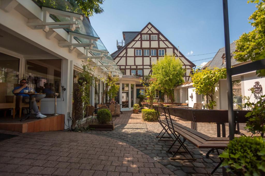 a cobblestone street in a town with buildings at Ferienresidenz Brauneberger Hof in Brauneberg