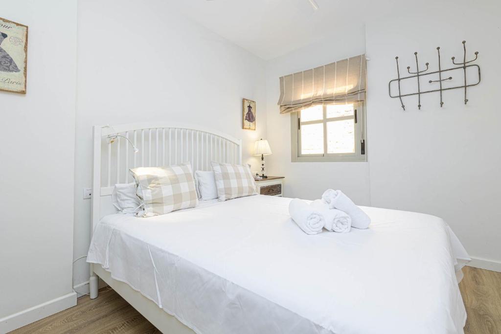 Łóżko lub łóżka w pokoju w obiekcie WintoWinRentals Genial Apartamento, Céntrico y Silencioso