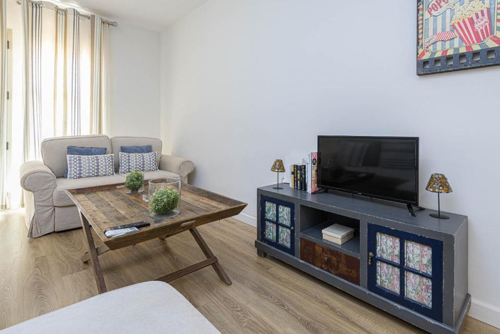Telewizja i/lub zestaw kina domowego w obiekcie WintoWinRentals Genial Apartamento, Céntrico y Silencioso